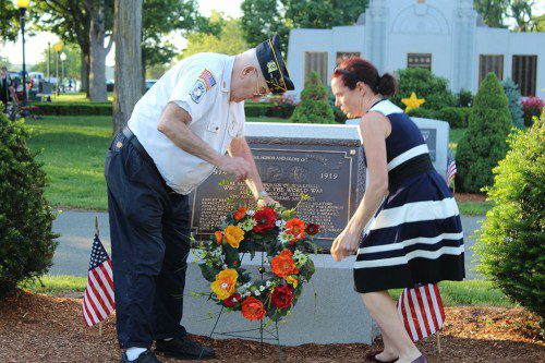 AMERICAN LEGION COMMANDER Tom Collins places a wreath in front of the newly refurbished World War I memorial on the Veterans Memorial Common during an annual Flag Day ceremony Wednesday. (Keith M. Curtis Photo)
