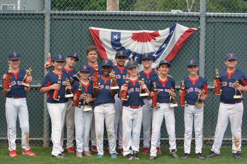 THE RED SOX pose with their trophies after winning the Wakefield Little League Championship. The Sox finished the season 22-1. From left to right, Tommy Stanley, Matt Beaver, Gianni Mercurio, Ken Branley, Phillip D’Alleva, Anthony Hykel, Adi Patel, Jack Stromski, John Porter, Tommy Grover, Bryce Olsen and Chris Munroe.