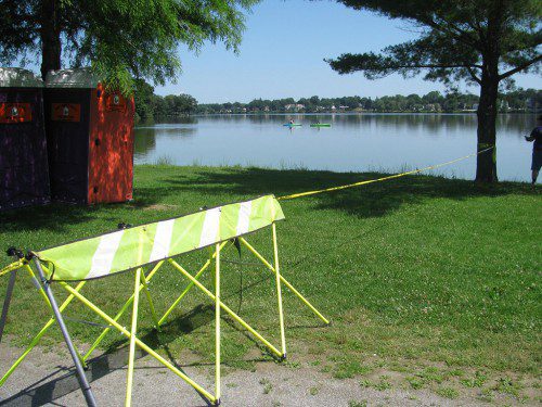 POLICE CORDONED OFF an area behind Veterans Field and the Hartshorne House Sunday morning while they recovered the body of a man that was in Lake Quannapowitt. Police have said that there were no early signs of foul play but the matter remains under investigation. (Mark Sardella Photo)