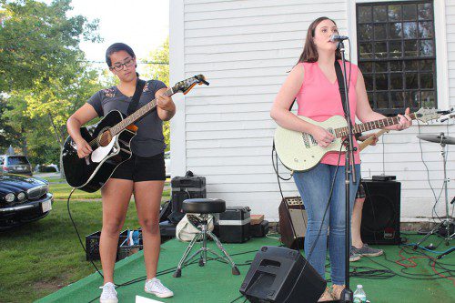 ASPIRING MUSICIANS Mia Daly (left) and Katy Morelli performed a cover of “My Church” by Maren Morris with Funbucket during the Rotary Club’s Concert on the Common July 26. (Dan Tomasello Photo)